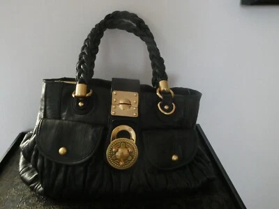 Bolso de hombro Steven by Steve Madden para mujer de cuero genuino negro dorado cierre giratorio Foto 1 de 4
