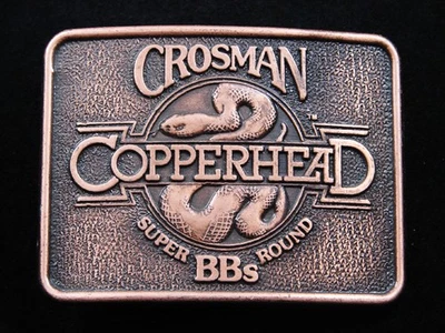 RH11113 *NOS* VINTAGE AÑOS 80 **CROSMAN CABEZA DE COBRE SUPER REDONDA BBS** HEBILLA DE CINTURÓN Foto 1 de 2