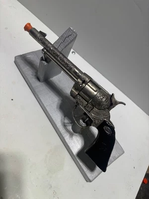 Pistola de casquillo vintage Leslie-Henry Gene Autry 44 Western con empuñaduras de madera Foto 1 de 4