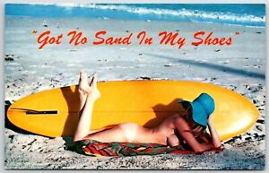 no sand in my shoes postcard risque woman lying by surf board beach