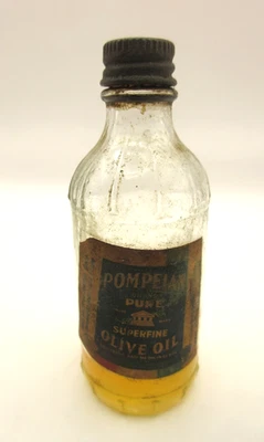 RARO! Botella de vidrio transparente de aceite de oliva pompeyano vintage de 4" con tapa de etiqueta y aceite Foto 1 de 4
