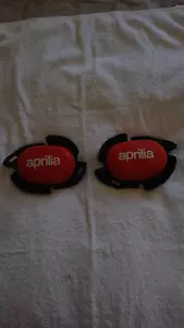 ULTRA RARE PAIR OF GENUINE APRILIA RACING KNEE SLIDERS -NEW - Picture 1 of 7