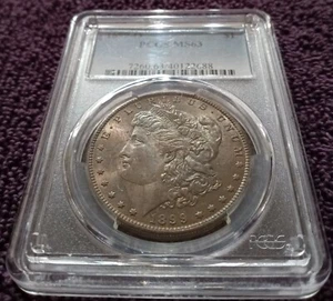 1899-O Morgan dollar, PCGS MS-63, extensive toning on one side. - Picture 1 of 4