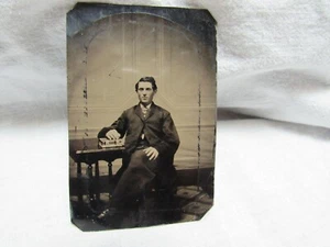 Antique Tintype Man Sitting At Table Hand on Clasped Antique Album 3-3/4”x2-1/2” - Picture 1 of 4