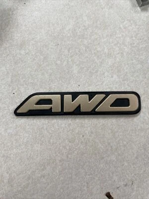 Subaru OEM 2000-2003 Outback Limited "AWD" Gold Rear Trunk Lid Emblem Logo Badge - Image 1 of 2