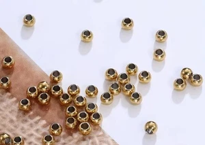 Lot 50 perles rondes acier inoxydable 3 mm dorées - Picture 1 of 1