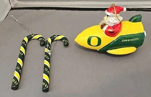 Lot 3 University of Oregon Ducks Ornament Santa In A Rocket Ship W 2 Candy Canes - Picture 1 of 6