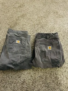 Dos pantalones Carhart 35x30 resistentes flexibles calce relajado doble rodilla y ajuste cargo - Imagen 1 de 21