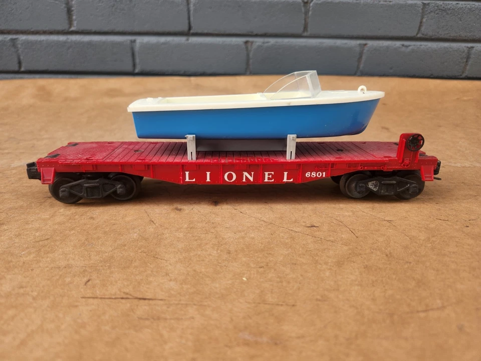 Postwar Lionel 6801 Red Flat Car with Original Blue Hull Boat Load - Image 1 of 4