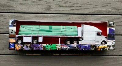 NEWRAY 1/32 WHITE VOLVO TRANSPORT TRUCK & FLATBED TRAILER W/ PIPE LOAD 14223 NIB - Image 1 of 4