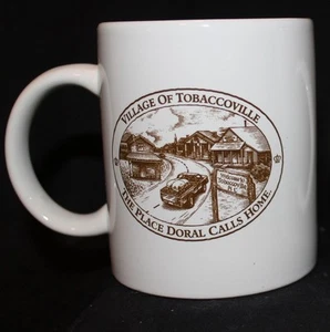COFFEE MUG DORAL VILLAGE OF TOBACCOVILLE "THE PLACE DORAL CALLS HOME" TOBACCO  - Picture 1 of 1