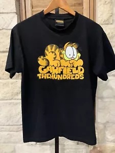 Camiseta Garfield Hombre Manga Corta Algodón "Los Cien" Negra Talla Mediana - Imagen 1 de 5