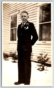 Photograph of Dapper Young Man Stands in Snow by House~Corsage~Metal & Kerchief - Picture 1 of 2