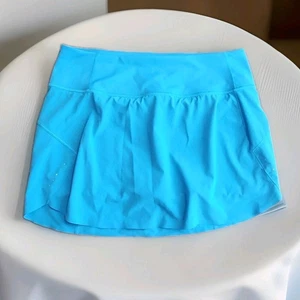 Pantalón corto Athleta Run With It 14" para mujer turquesa elástico cremallera bolsillo talla M - Imagen 1 de 10