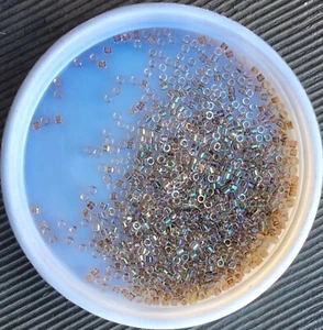 11/0 JAPANESE Seed Beads, Delica®, Lined Ivory AB (DB64, DB064, DB0064), 5g - Picture 1 of 1