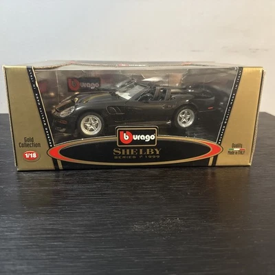 BURAGO 1999 SHELBY SERIE 1 1/18-NEGRO Y DORADO Foto 1 de 4