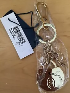 Dooney & Bourke Samba Lock & Key Fob in GOLD TONE - Picture 1 of 3