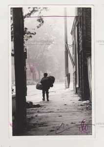 Korbverkäufer auf urbanen Straßen markanter Kontrast von Land- & Stadtleben abstrakt - Bild 1 von 1