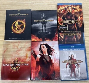 The Hunger Games DVD + Catching Fire Blu ray TARGET EX + MOCKING JAY Part 1 & 2 - Bild 1 von 1