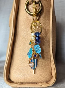 LLAVERO BOLA PEPINILLO DORADO BOLSO AZUL ENCANTO MONEDERO ENCANTO MOCHILA ENCANTO - Imagen 1 de 7