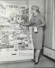 1959 Press Photo A woman checks various travel brochures at rack - lra68746