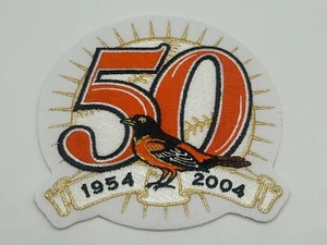 TOPPA MANICA IN MAGLIA CASA 2004 BALTIMORE ORIOLES 50° ANNO UFFICIALE MLB BASEBALL - Foto 1 di 6