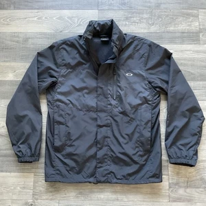 Chaqueta cortavientos Oakley para hombre MEDIANA negra con capucha cremallera completa con capucha forrada de malla - Imagen 1 de 14