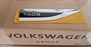 2GJ853688A DPJ BRAND NEW GENUINE  VW    RIGHT FRONT  EMBLEM " TAOS "  2022- 2024 - Picture 1 of 2