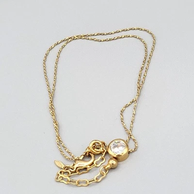 Collar Avon en tono dorado con colgante de cristal transparente y cadena ajustable Foto 1 de 4