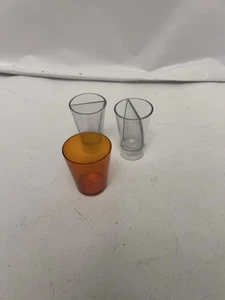 3 plastic shot glasses, 1 orange, clear split shot - Picture 1 of 3