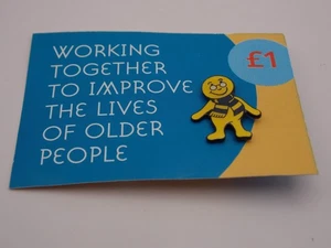 Help The Aged pin badge little yellow person wearing a striped scarf - Picture 1 of 2
