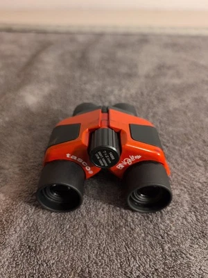 Tasco Infocus 7x21mm Red Color Mini Binoculars 342 Feet To 1000 Yards Range - Image 1 of 4