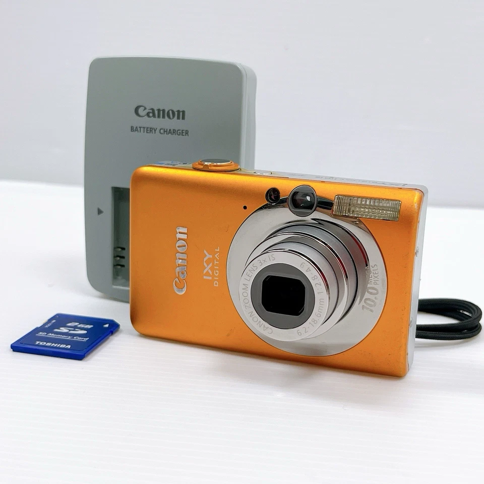 Restaurada Excelente+ Cámara Compacta Canon IXY Digital 110 IS Naranja Probada Foto 1 de 4