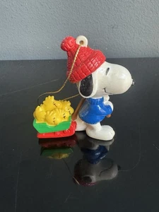 Vintage PEANUTS Christmas Ornament Snoopy Pulling Sled With Woodstocks Holiday - Picture 1 of 5