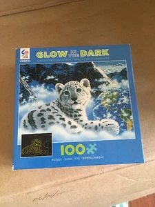 Rompecabezas de leopardo de las nieves 100 piezas que brillan en la oscuridad (2016, Ceaco) Schim Schimmel - Imagen 1 de 5