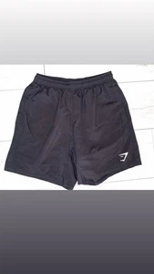 Pantalones cortos deportivos para hombre Gymshark talla pequeña negros con logotipo blanco  - Imagen 1 de 9