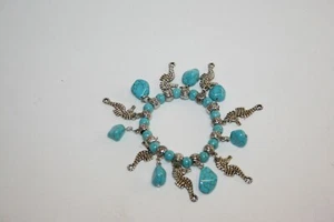 Faux Turquoise Beaded Stretch Bracelet with Silver-Tone Seahorse Charms - Picture 1 of 2
