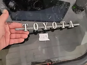 VINTAGE 1970S TOYOTA KE20 COROLLA REAR DECK EMBLEM SCRIPT OEM - Picture 1 of 5