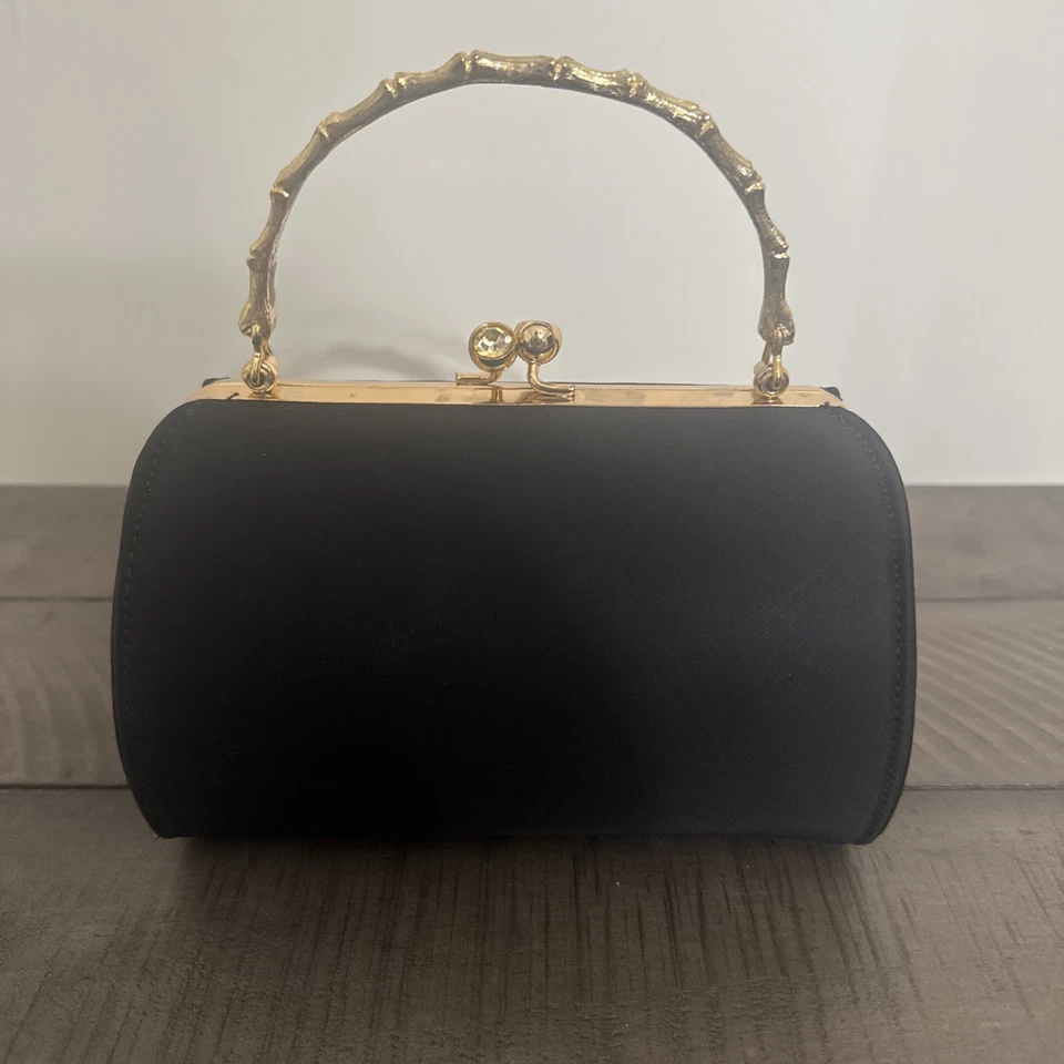 Cartera o bolso de mano vintage Ande’ negro con asa dorada Foto 1 de 4