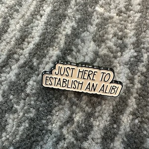 Alibi Enamel Pin Just Here To Establish Spell Out Lapel Backpack True Crime New - Picture 1 of 4