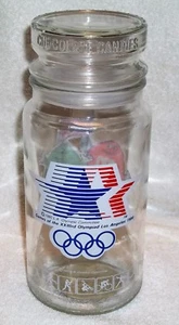M&M Glas mit Deckel Spiele der XXIII Olympischen Spiele Mars INC.1983 Anchor HOCKINGS Glas - Bild 1 von 9