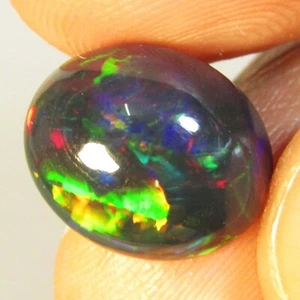 Piedra preciosa ovalada de ópalo negro multicolor natural intermitente de 4,25 quilates de Etiopía - Imagen 1 de 7