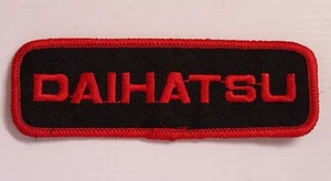 VINTAGE DAIHATSU EMBROIDERED PATCH WOVEN CLOTH BADGE SEW-ON MOTOR RACING RED - Picture 1 of 1