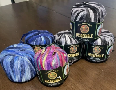 6 Skeins Varigated Incredible Lion Brand Yarn Black & White, Blues & Carnival - Image 1 of 4