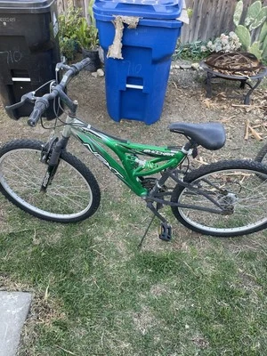 GOOD CONDITION BIKE GREEN ALUMINUM WITH SUSPENSION AND COIL FOR SHOCK ABSORBING. - Image 1 of 4