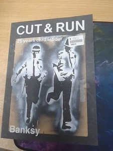 Cut and Run Banksy Paperback Book 25 Years of Card Labour - Bild 1 von 2