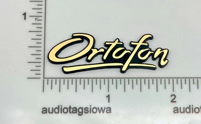 Etiqueta con logotipo de insignia Ortofon hecha a medida acrílico inciso autoadhesivo dorado Foto 1 de 4