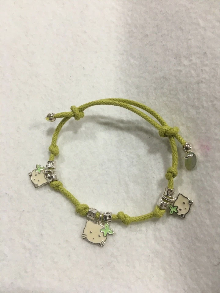 BRACCIALE BIMBO BIMBA IN ARGENTO CON CIONDOLI E CORDONE  VERDE MELA  - Immagine 1 di 1