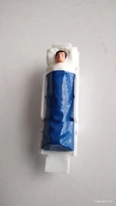 Dinky Toy stretcher and patient with blue blanket - Picture 1 of 2