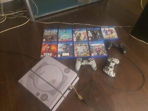 PlayStation 4 with 3 controllers, 9 physical games and over 100 digital games